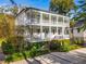 Two-story home with wraparound porch, metal roof, and lush landscaping at 436 Church St, Mount Pleasant, SC 29464