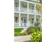 Two-story home with a beautiful front porch, lush landscaping, and an inviting entrance at 436 Church St, Mount Pleasant, SC 29464