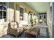 Relaxing front porch with wicker furniture and coffee table at 436 Church St, Mount Pleasant, SC 29464