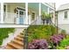 Inviting front porch with elaborate staircase and lush landscaping at 436 Church St, Mount Pleasant, SC 29464