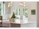 Kitchen island with marble top, farm sink, and French doors to patio at 436 Church St, Mount Pleasant, SC 29464