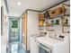 Convenient laundry room with shelving, and a built-in bench at 436 Church St, Mount Pleasant, SC 29464