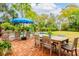Brick patio with pool view, dining table, and umbrella at 436 Church St, Mount Pleasant, SC 29464