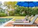 Poolside lounge chairs on brick patio with umbrella at 436 Church St, Mount Pleasant, SC 29464