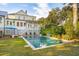 Inviting backyard oasis featuring a spacious pool, lush landscaping, and a charming patio area at 436 Church St, Mount Pleasant, SC 29464
