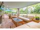 Relaxing screened porch with brick flooring, comfortable seating, and a view of the yard at 436 Church St, Mount Pleasant, SC 29464