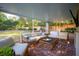 Spacious screened-in porch with brick floor, wicker furniture, and a fireplace at 436 Church St, Mount Pleasant, SC 29464