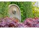Stunning lion head fountain nestled in a vibrant garden with colorful plants at 436 Church St, Mount Pleasant, SC 29464