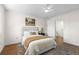 Stylishly staged bedroom with hardwood floors, area rug, plants, a queen-size bed and entry to another room at 4796 Champion Way # C, North Charleston, SC 29418