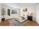 Stylishly staged bedroom with hardwood floors, area rug, plants and a queen-size bed at 4796 Champion Way # C, North Charleston, SC 29418
