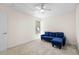 Bright bedroom featuring plush carpet, white ceiling fan, and a cozy blue sofa at 4796 Champion Way # C, North Charleston, SC 29418