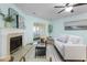Well-lit living room with sliding glass doors, stylish furniture, and a decorative fireplace at 4796 Champion Way # C, North Charleston, SC 29418