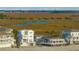 Elevated beach home, marsh views, and bridge in background at 1579 E Ashley Ave, Folly Beach, SC 29439
