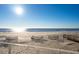 Oceanfront view with sandy beach and dune fencing at 1579 E Ashley Ave, Folly Beach, SC 29439