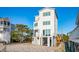 Beachfront home with modern white exterior and elevated deck at 1579 E Ashley Ave, Folly Beach, SC 29439