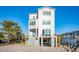 Beachfront home with modern white exterior and elevated deck at 1579 E Ashley Ave, Folly Beach, SC 29439