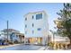Three-story beach home with white siding and stairs at 1579 E Ashley Ave, Folly Beach, SC 29439