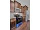 Stainless steel appliances and dark wood cabinets in kitchen at 1625 Pimlico Blvd, Moncks Corner, SC 29461