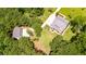 Aerial view of a home with two buildings on a large lot with lush landscaping at 2972 Anchor Watch Dr, Wadmalaw Island, SC 29487