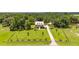 Aerial view of expansive property with a two-story home, landscaping and long driveway at 2972 Anchor Watch Dr, Wadmalaw Island, SC 29487