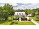 Stunning aerial view of a two-story home with metal roof, large yard and driveway at 2972 Anchor Watch Dr, Wadmalaw Island, SC 29487