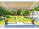 Grey composite deck with awning, offering shade and views of the backyard at 2972 Anchor Watch Dr, Wadmalaw Island, SC 29487