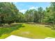Large grassy backyard with mature trees at 2972 Anchor Watch Dr, Wadmalaw Island, SC 29487