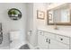 Bathroom boasts white vanity, quartz countertop and decorative mirror at 2972 Anchor Watch Dr, Wadmalaw Island, SC 29487