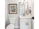 Powder room with white vanity and decorative art at 2972 Anchor Watch Dr, Wadmalaw Island, SC 29487