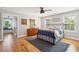 Cozy bedroom with hardwood floors, a metal bed frame, and window seating at 2972 Anchor Watch Dr, Wadmalaw Island, SC 29487