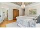 Primary bedroom features a view into the sunroom and hardwood floors at 2972 Anchor Watch Dr, Wadmalaw Island, SC 29487