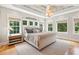 Spacious primary bedroom with hardwood floors, beamed ceiling, and large windows at 2972 Anchor Watch Dr, Wadmalaw Island, SC 29487