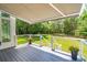 Spacious deck with awning, overlooking a lush backyard at 2972 Anchor Watch Dr, Wadmalaw Island, SC 29487