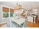 Farmhouse dining area with view to the backyard from multiple windows at 2972 Anchor Watch Dr, Wadmalaw Island, SC 29487