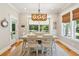 Bright dining area with farmhouse table, chairs, and natural light at 2972 Anchor Watch Dr, Wadmalaw Island, SC 29487