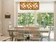 Kitchen dining area features a farmhouse table and chairs, with a view to the backyard at 2972 Anchor Watch Dr, Wadmalaw Island, SC 29487