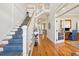 Bright entryway with hardwood floors, staircase, and view to living area at 2972 Anchor Watch Dr, Wadmalaw Island, SC 29487