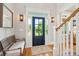 Entryway with hardwood floors, bench, and black front door at 2972 Anchor Watch Dr, Wadmalaw Island, SC 29487