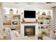 Fireplace with built-in shelving and shiplap wall at 2972 Anchor Watch Dr, Wadmalaw Island, SC 29487
