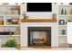 Modern fireplace with a shiplap wall and built-in shelving at 2972 Anchor Watch Dr, Wadmalaw Island, SC 29487