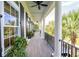 Spacious front porch with white columns, gray flooring, and hanging planter at 2972 Anchor Watch Dr, Wadmalaw Island, SC 29487