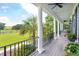 Front porch with white columns, gray flooring, and view of yard at 2972 Anchor Watch Dr, Wadmalaw Island, SC 29487