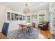 Study with built-in shelving, hardwood floors, and a rustic wooden table at 2972 Anchor Watch Dr, Wadmalaw Island, SC 29487