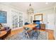 Home office with hardwood floors, French doors, and a wooden work table at 2972 Anchor Watch Dr, Wadmalaw Island, SC 29487