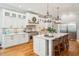 Island kitchen features white cabinets, quartz countertops, and stainless steel appliances at 2972 Anchor Watch Dr, Wadmalaw Island, SC 29487
