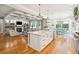 Open concept kitchen boasts a large island, stainless steel appliances, and white cabinetry at 2972 Anchor Watch Dr, Wadmalaw Island, SC 29487