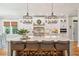 Bright kitchen with white cabinets, a large island, and hardwood floors at 2972 Anchor Watch Dr, Wadmalaw Island, SC 29487