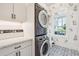 Bright laundry room with stackable washer and dryer, and decorative wall accents at 2972 Anchor Watch Dr, Wadmalaw Island, SC 29487