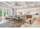 Bright living room with an open floor plan, showcasing a kitchen and access to outdoor space at 2972 Anchor Watch Dr, Wadmalaw Island, SC 29487
