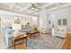 Open living room featuring hardwood floors, a cozy seating area, and a view into the kitchen at 2972 Anchor Watch Dr, Wadmalaw Island, SC 29487